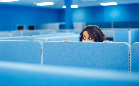 Office worker eavesdropping in cubicle room