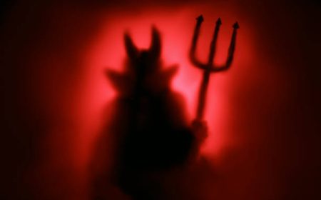 Creepy Devil silhouette from hell in the mist with backlit.